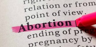 "Abortion" highlighted in a dictionary with a pink marker.