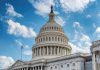 U.S. Capitol building dome under a blue sky.