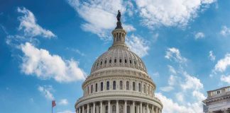 U.S. Capitol building dome under a blue sky.