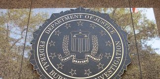 FBI seal on marble wall in daylight.