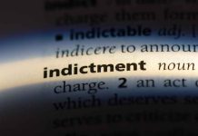 Close-up of the word indictment in a dictionary