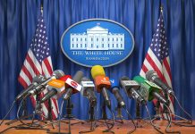 Multiple microphones at White House press briefing podium.