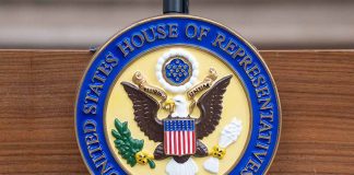 United States House of Representatives emblem on a podium.