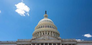 U.S. Capitol building against a clear blue sky.