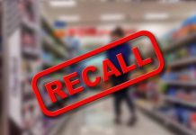 "Recall" stamp on blurred store aisle background.