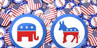 Republican elephant and Democratic donkey buttons, surrounded by flags.