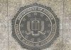 FBI emblem on Department of Justice building wall.