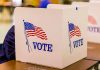 Voting booth with American flag and "VOTE" text.