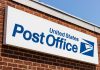 United States Post Office sign on brick building.