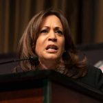 Woman speaking at a podium.