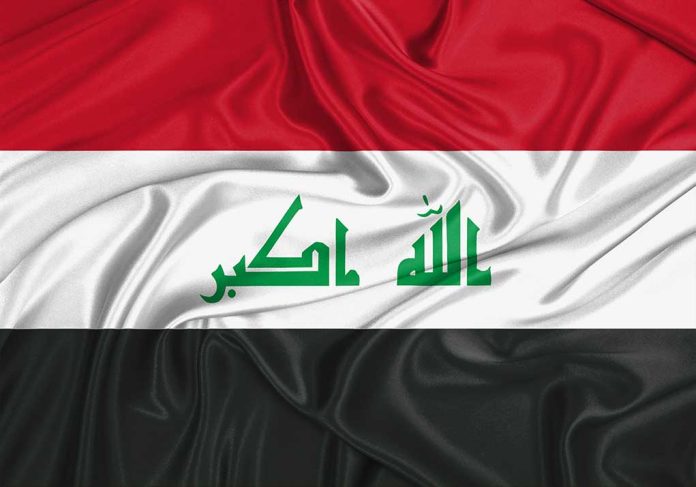 Iraq flag with Arabic script on white stripe