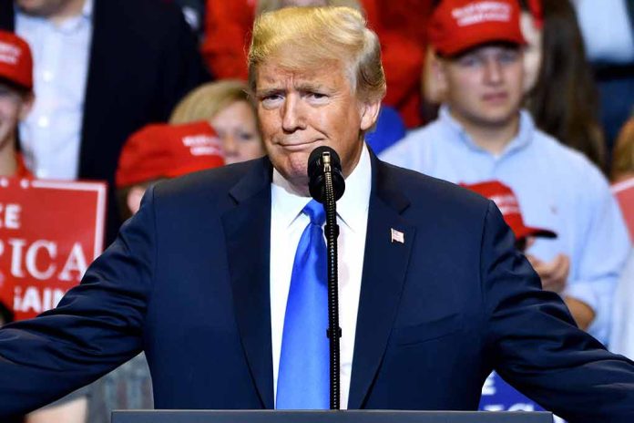 Man in suit speaking at a rally.