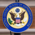 United States House of Representatives emblem on a podium.