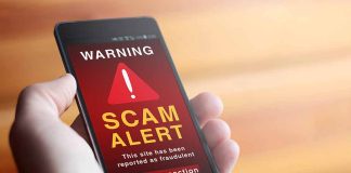 Phone showing scam alert warning message.