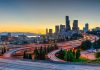 City skyline with highways at sunset.