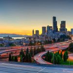 City skyline with highways at sunset.