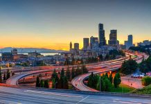 City skyline with highways at sunset.