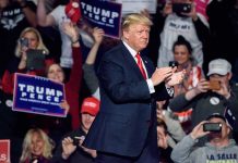 Person clapping at a political rally event.