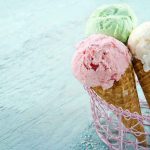 Three ice cream cones in a pink basket.