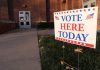 "Vote Here Today" sign outside a building entrance.