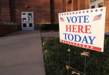 "Vote Here Today" sign outside a building entrance.