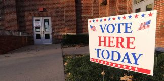 "Vote Here Today" sign outside a building entrance.