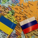 Ukrainian and Russian flags on map of Europe