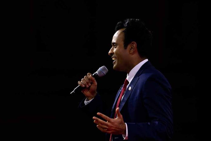 2270821277 featured image Man in suit speaking into microphone on stage