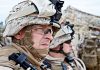 Military personnel in camouflage gear and helmets outdoors