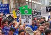 Pro-life rally with people holding various signs.