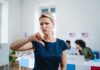 Woman with thumbs down in voting location.