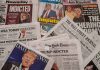 Newspaper headlines about Trump indictment and charges.