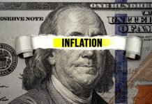 "Inflation" text over torn hundred-dollar bill.