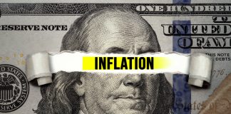 "Inflation" text over torn hundred-dollar bill.