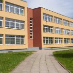 Threestory yellow building with many windows