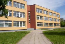 Threestory yellow building with many windows