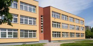 Threestory yellow building with many windows