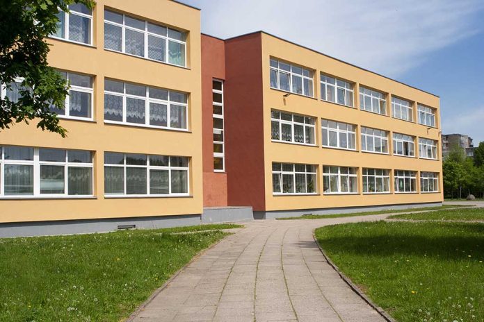 Threestory yellow building with many windows