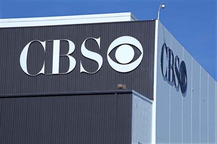 CBS logo on building exterior under blue sky.