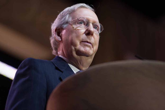 Man in suit looking upwards with glasses on