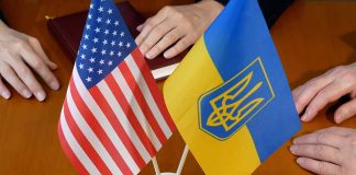 Flags of USA and Ukraine on table