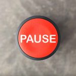 Red button labeled "PAUSE" on gray background.