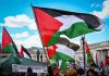 Protest with Palestinian flags waving in the air