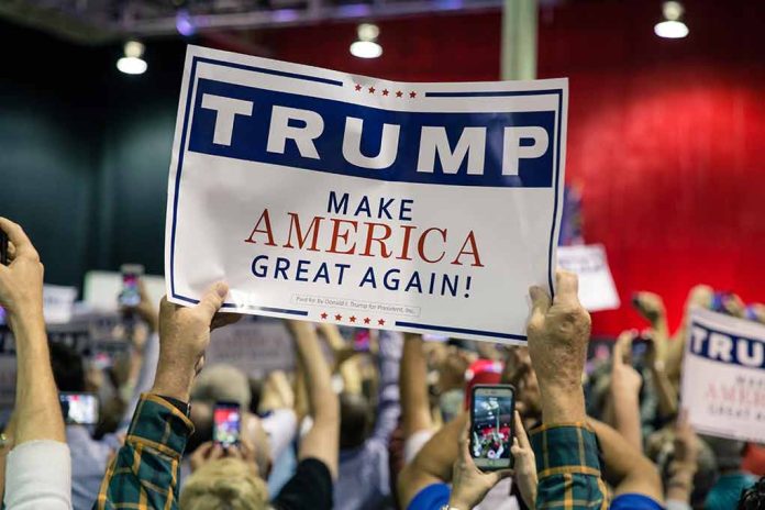 Sign at crowded rally for Trump campaign.