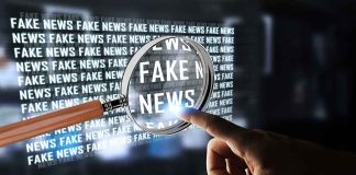 Hand pointing at fake news through magnifying glass