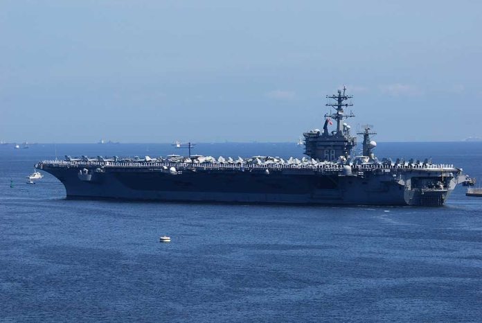 1340097212 featured image Aircraft carrier sailing on the ocean blue sky