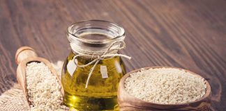 Jar of oil, sesame seeds in bowl.