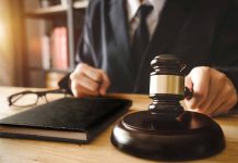 Gavel on table with glasses and notebook