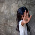 Person with an X on their palm