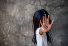 Person with an X on their palm